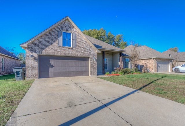 view of front facade with a front yard and a garage