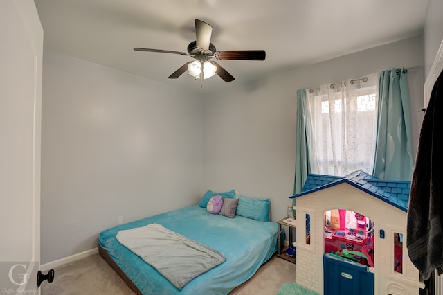 bedroom featuring ceiling fan and light carpet