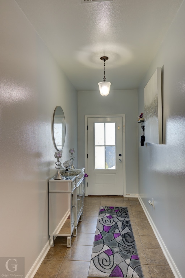 doorway to outside featuring tile patterned floors