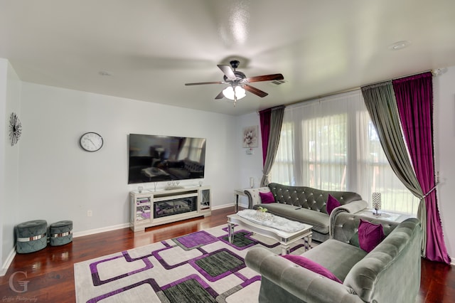 living room with ceiling fan and dark wood-type flooring