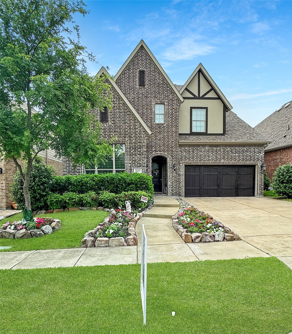 tudor-style house with a front yard and a garage