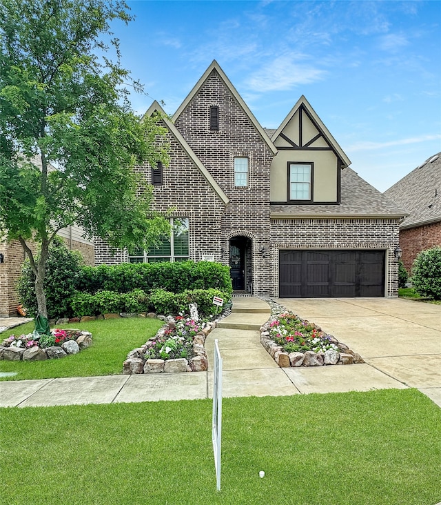 tudor-style house with a front yard and a garage