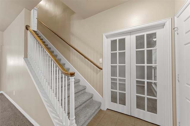 staircase featuring tile patterned flooring