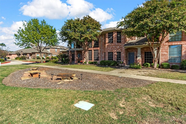 575 S Virginia Hills Dr Unit 303, Mckinney, TX 75072 - view of front of house featuring a front lawn and brick siding
