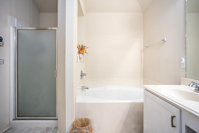 bathroom featuring plus walk in shower and vanity