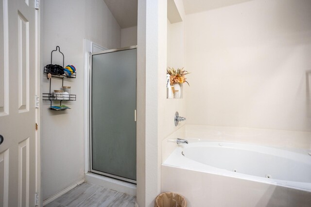 bathroom featuring independent shower and bath