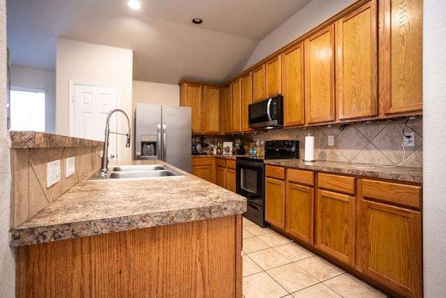 kitchen featuring sink, stainless steel appliances, vaulted ceiling, decorative backsplash, and light tile patterned flooring