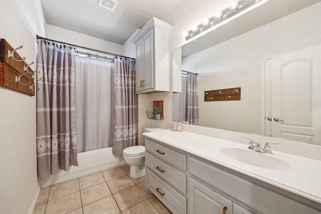 full bathroom featuring toilet, vanity, tile patterned floors, and shower / bath combination with curtain