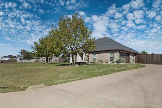 view of front facade featuring a garage and a front lawn