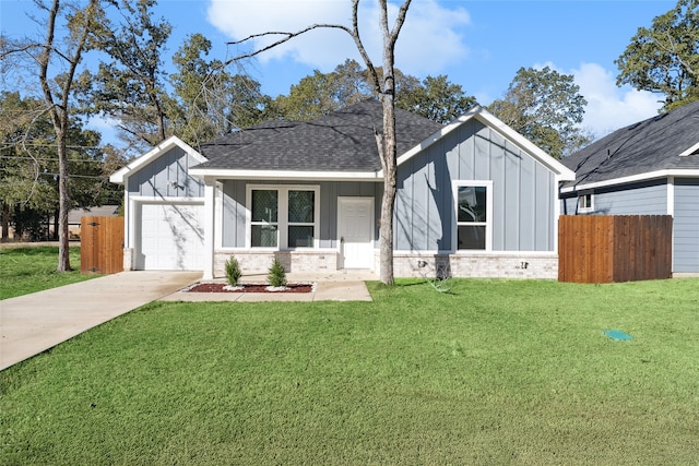 view of front of property with a garage and a front yard