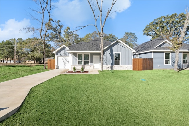 view of front of property with a garage and a front lawn