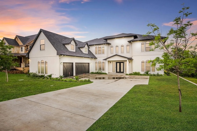 view of front of home featuring french doors and a lawn