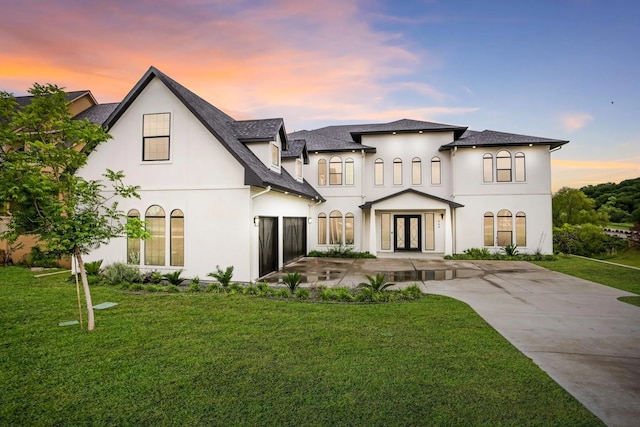 view of front of house with a yard and french doors