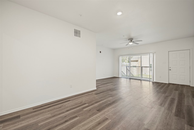 unfurnished room with ceiling fan and dark wood-type flooring