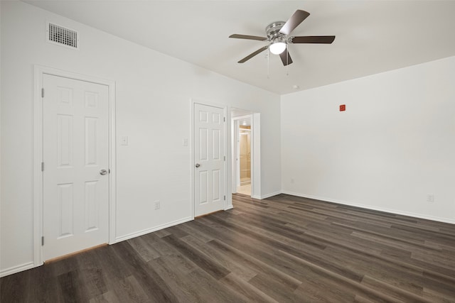 empty room with ceiling fan and dark hardwood / wood-style floors