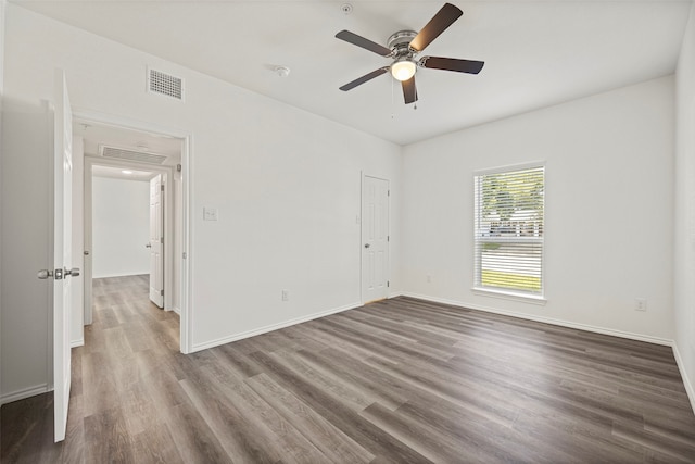 spare room featuring ceiling fan and dark wood-type flooring