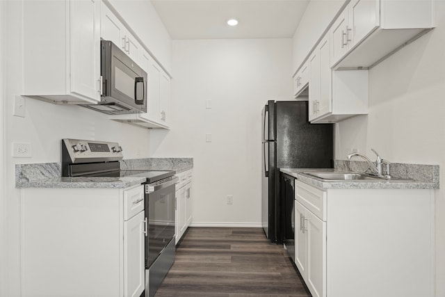 kitchen with white cabinets, appliances with stainless steel finishes, and dark wood-type flooring