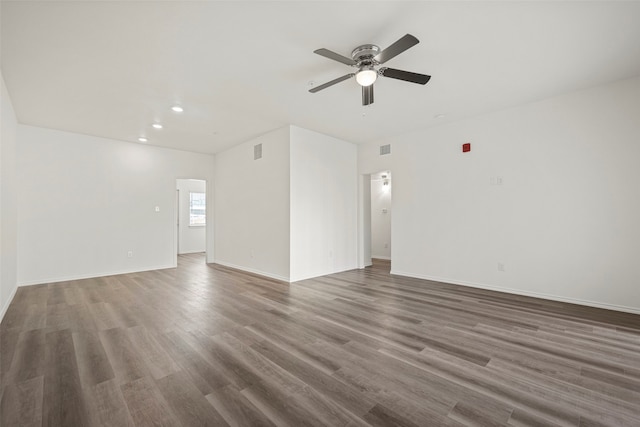 spare room featuring ceiling fan and dark hardwood / wood-style flooring