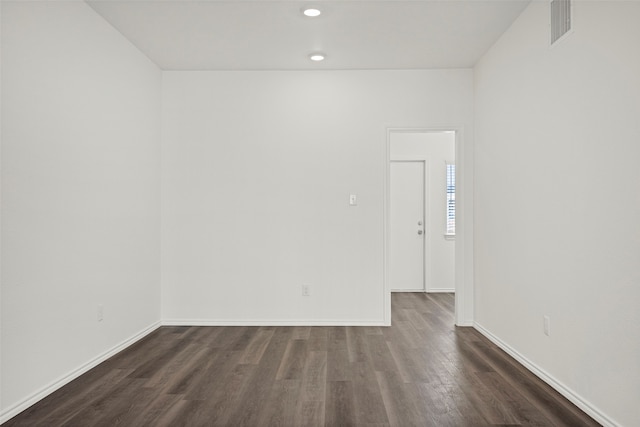 spare room with dark hardwood / wood-style floors