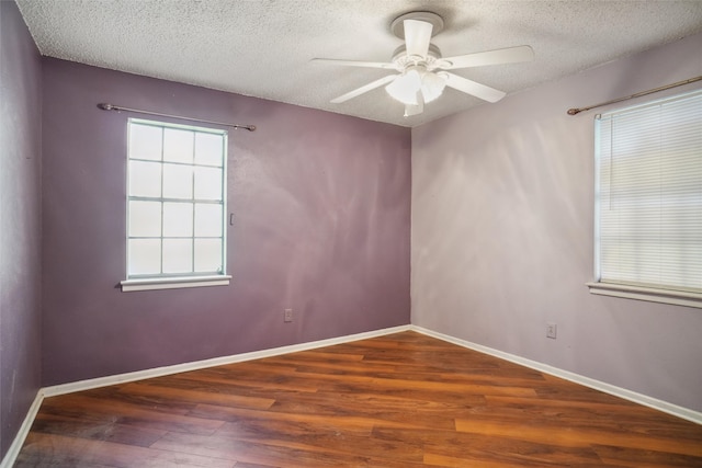 spare room featuring ceiling fan, dark hardwood / wood-style flooring, and a textured ceiling