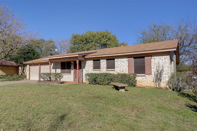 ranch-style home featuring a garage and a front lawn