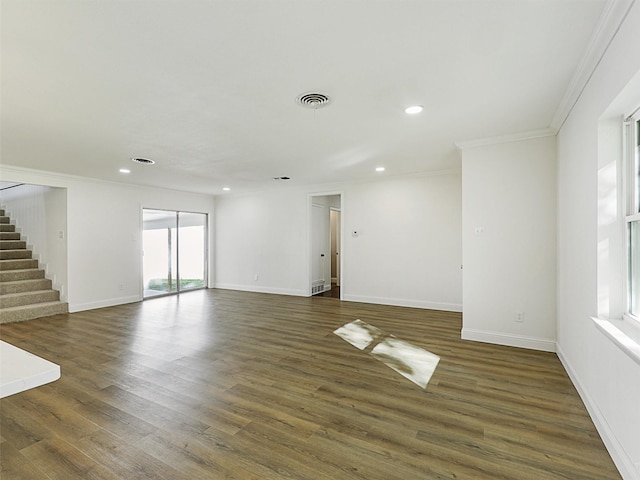 empty room featuring ornamental molding and dark hardwood / wood-style floors