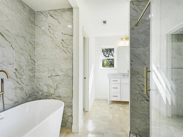 bathroom with vanity and independent shower and bath