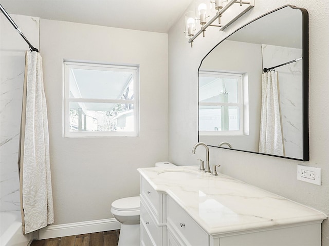 full bathroom with vanity, toilet, wood-type flooring, and shower / tub combo