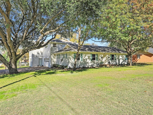 view of front of property with a front yard and a garage