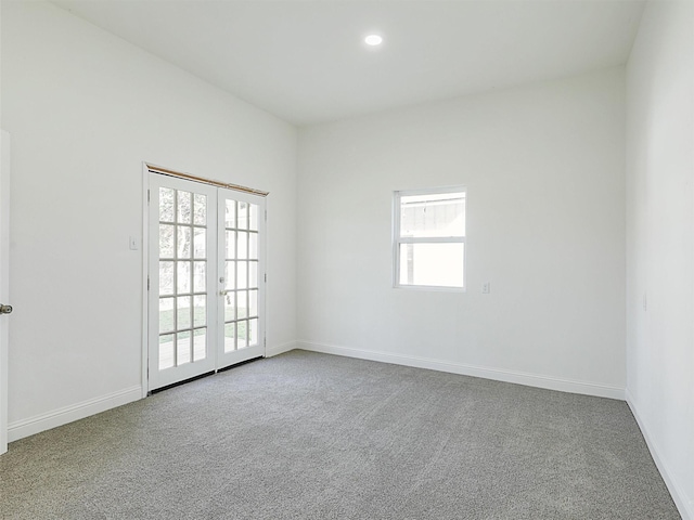 unfurnished room featuring carpet and french doors