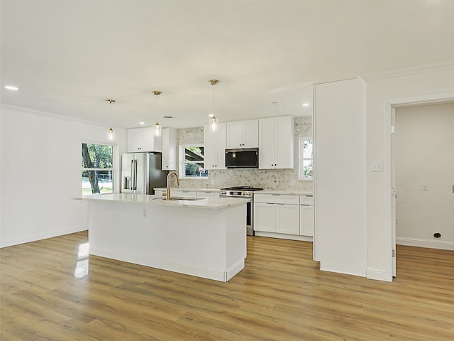 kitchen featuring white cabinetry, sink, stainless steel appliances, and light hardwood / wood-style flooring