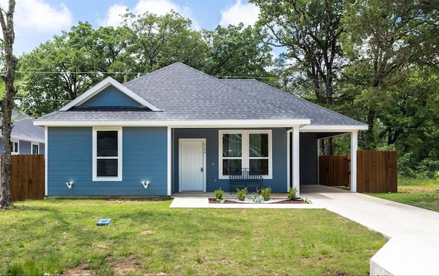 view of front of property with a front yard, a carport, and covered porch