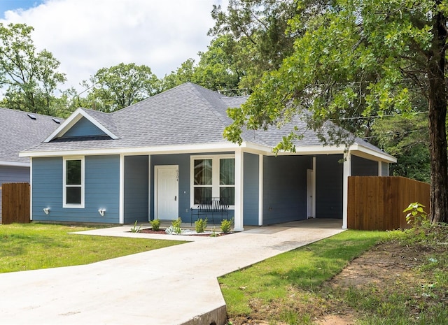 view of front of property with a front lawn, a porch, and a carport