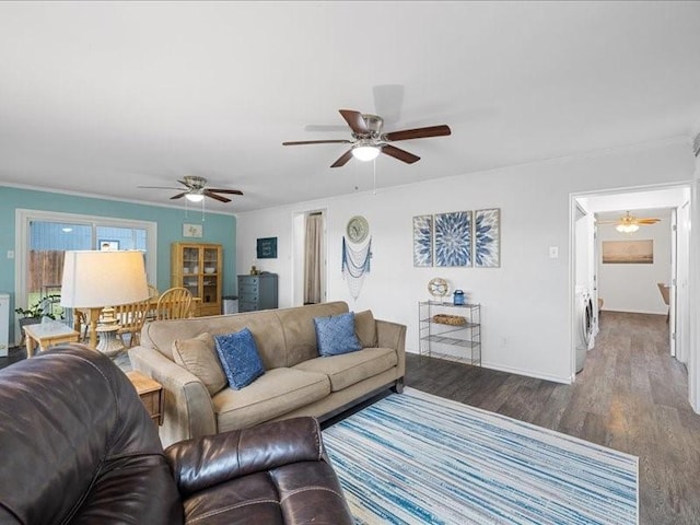 living room featuring hardwood / wood-style flooring, crown molding, ceiling fan, and washer / clothes dryer