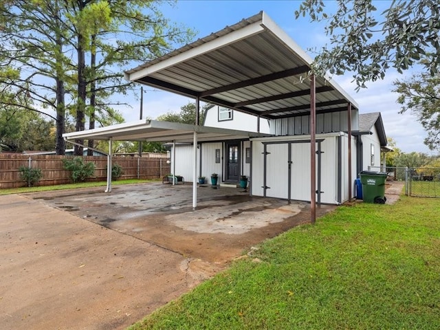 view of car parking featuring a yard and a carport