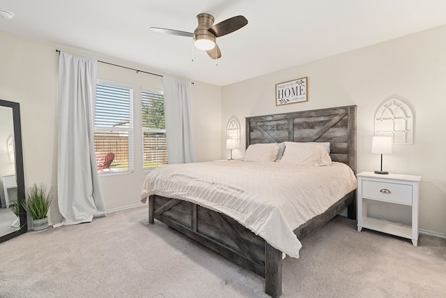 bedroom featuring light colored carpet and ceiling fan