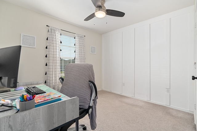 home office with ceiling fan and light carpet