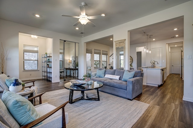 living room featuring french doors, ceiling fan, dark wood-type flooring, and sink