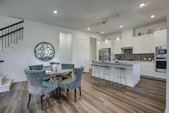 dining area with wood-type flooring