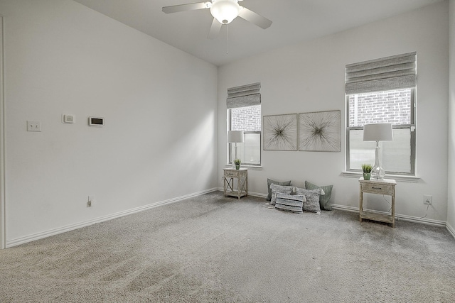 unfurnished room featuring ceiling fan and carpet floors