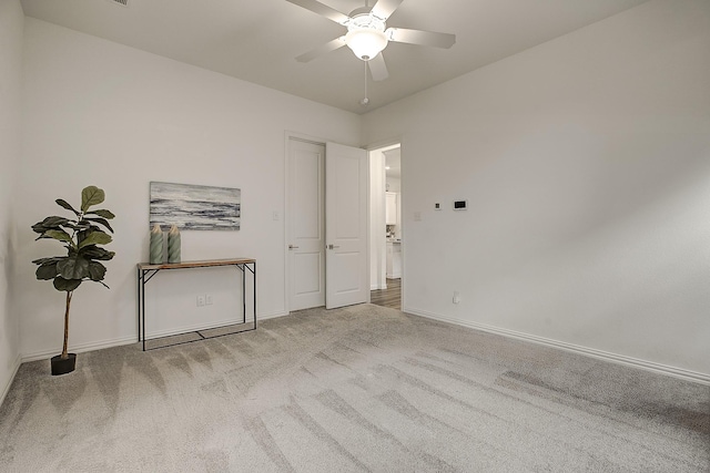 carpeted empty room with ceiling fan