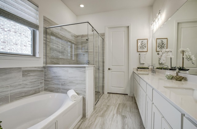 bathroom with vanity and separate shower and tub