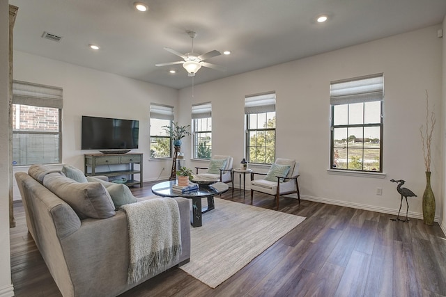 living room featuring dark hardwood / wood-style floors and ceiling fan