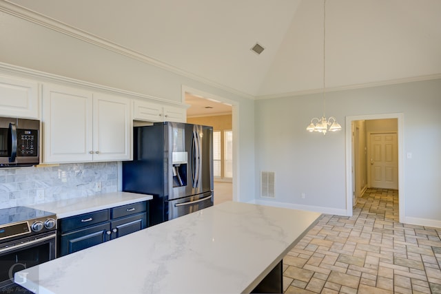 kitchen with a chandelier, stainless steel appliances, white cabinetry, decorative light fixtures, and backsplash