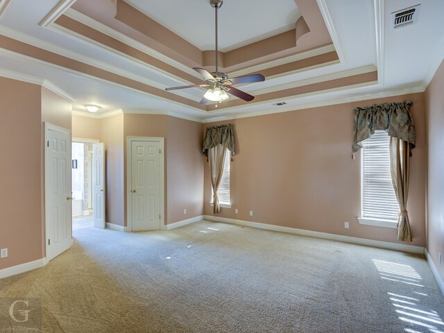 spare room with light carpet, ceiling fan, and ornamental molding