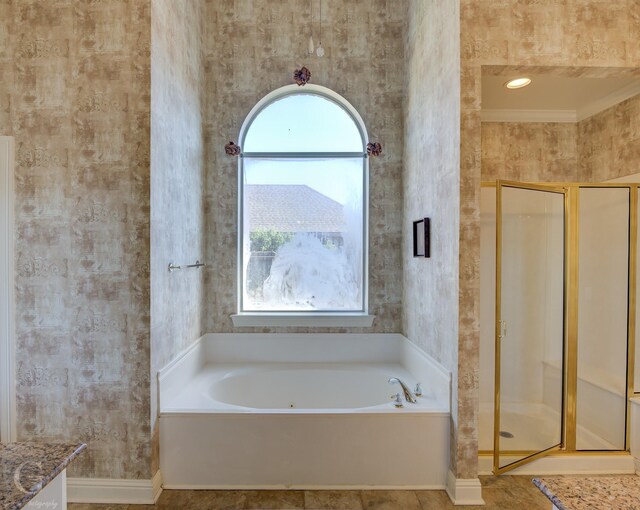 bathroom with crown molding and plus walk in shower