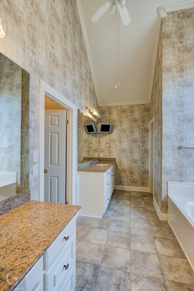 bathroom with vanity, ornamental molding, ceiling fan, high vaulted ceiling, and a bathing tub