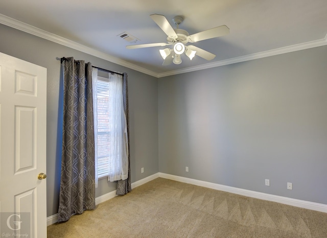 empty room featuring ceiling fan, ornamental molding, and light carpet