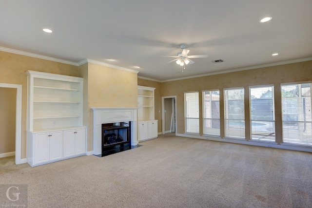 unfurnished living room featuring ceiling fan, light colored carpet, and crown molding