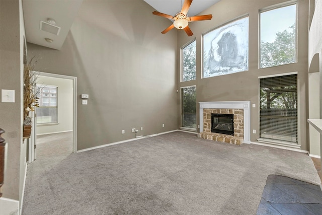 unfurnished living room with a towering ceiling and a healthy amount of sunlight